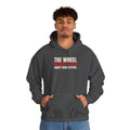 The Wheel Doesn't Care About Your System. — Roulette Hoodie (Dark Heather, worn, front)