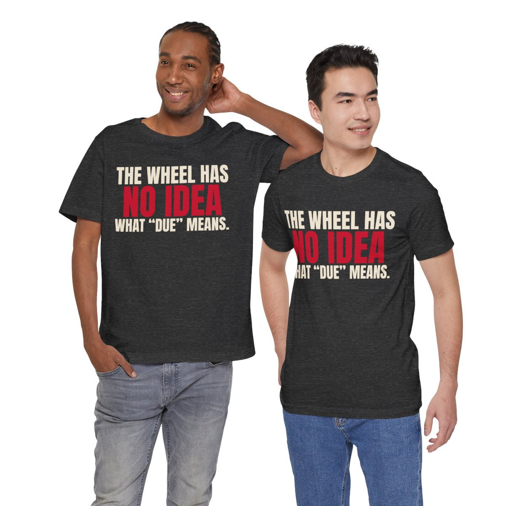 The Wheel Has No Idea What "Due" Means. — Roulette Tee (Dark Grey Heather, worn by two, front)