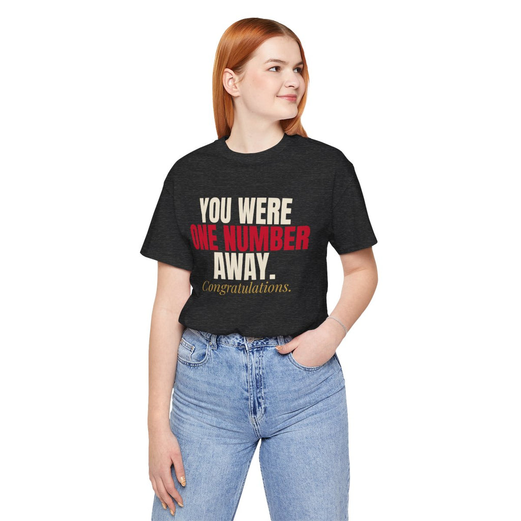You Were One Number Away. Congratulations. — Roulette Tee (Dark Grey Heather, worn, front)